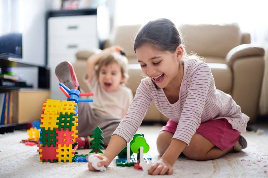 Parent and toddler playing short counting game with toys for personalized home learning
